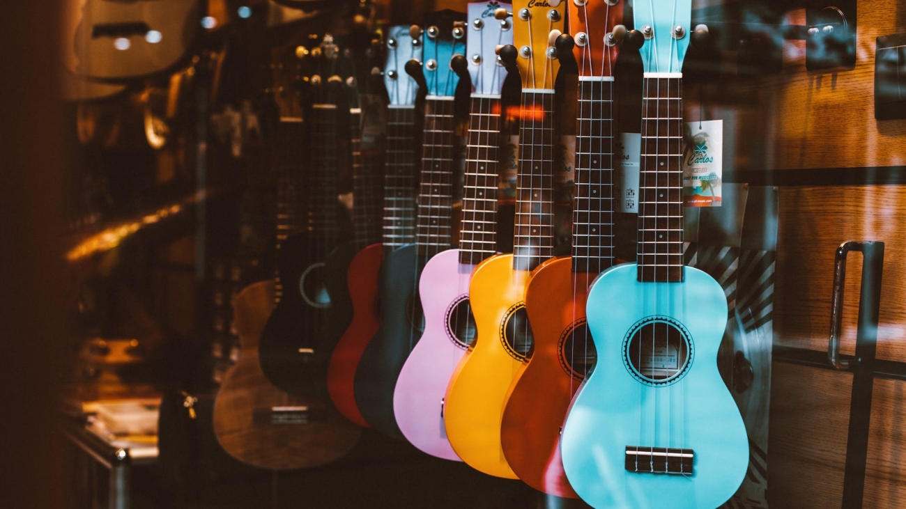 colorful guitars hanging behind the glass window