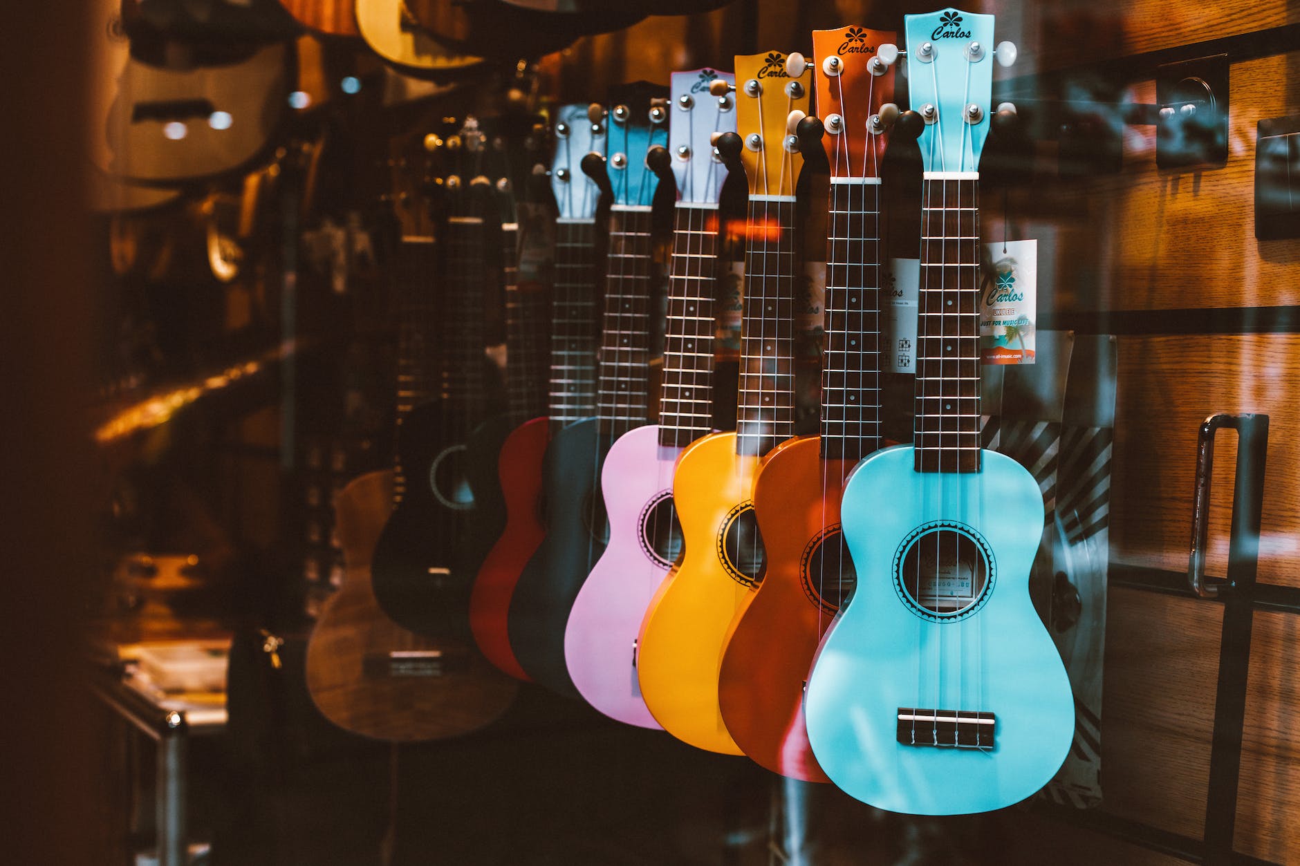 colorful guitars hanging behind the glass window